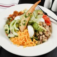 Chicken Cobb Salad · Customer favorite. Crisp greens, grilled marinated chicken, cheddar cheese, avocado, crumble...