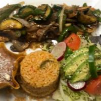 Pollo Juanito · Chicken Breast cooked w/ sweet peppers, mushrooms & onions. Served w/ refried beans, rice & ...