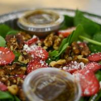 Spinach Salad · Fresh spinach topped with crumbled goat cheese, walnuts and sliced strawberries. Served with...