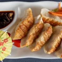 Pan-Fried Dumpling · Homemade pan-fried dumplings filled with pork and chives served with house ginger and garlic...