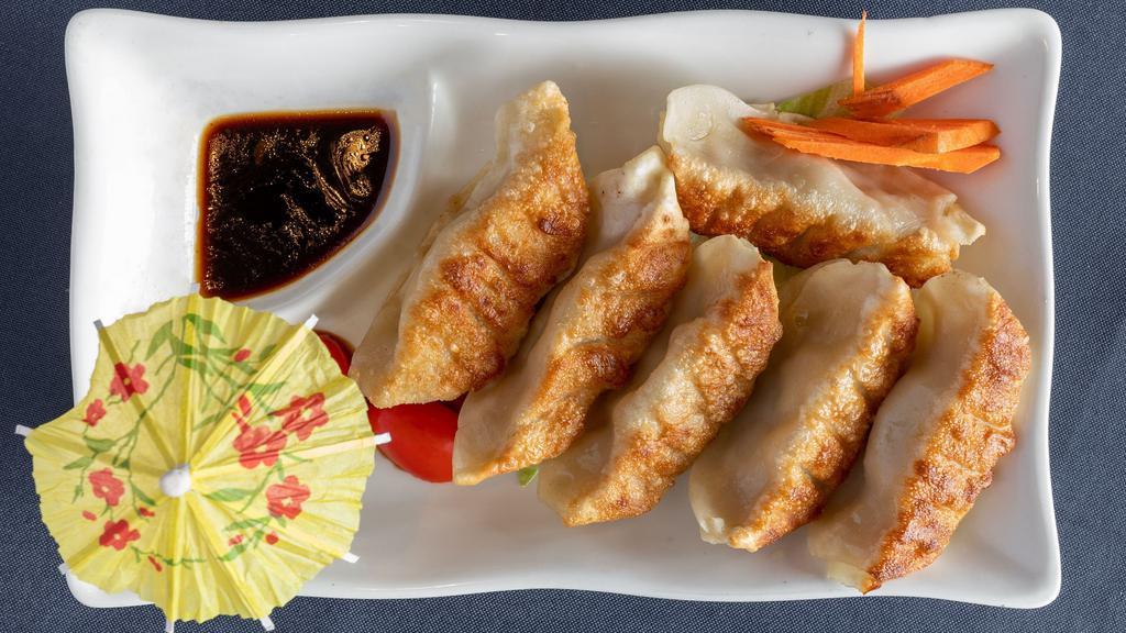 Pan-Fried Dumpling · Homemade pan-fried dumplings filled with pork and chives served with house ginger and garlic sauce.