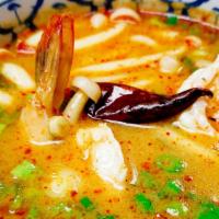 Tom Yum Koong · Hot. Hot and sour shrimp soup with lemongrass, lime juice, mushrooms, bell peppers, onions, ...
