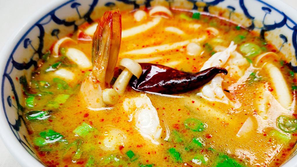 Tom Yum Koong · Hot. Hot and sour shrimp soup with lemongrass, lime juice, mushrooms, bell peppers, onions, scallions and hot chili paste.(Large $11.90)