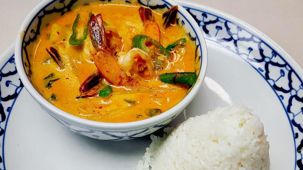 Gang Dang · Hot. Red curry and coconut milk with bamboo shoots, bell peppers, onions, lime leaves and basil leaves.