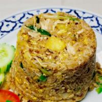 Pineapple Fried Rice · Fluffy stir fried white rice mixed with egg, pineapple, peas, carrots, onion, scallion, turm...