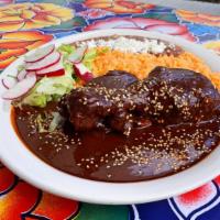Mole Oaxaqueno · Authentic dark chicken mole made with chiles and spices from Oaxaca including cinnamon, choc...