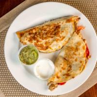 Fajita Quesadilla · Two quesadillas with tender beef or chicken, grilled onion, bell pepper, guacamole and sour ...
