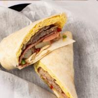 Breakfast Burrito · Two scambled eggs with either sausage, bacon, or ham with home fries and  melted cheese in a...