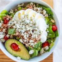 Cobb · Romaine, sliced hard boiled egg, cherub tomatoes, bacon, 1/2 an avocado, green onions, toppe...