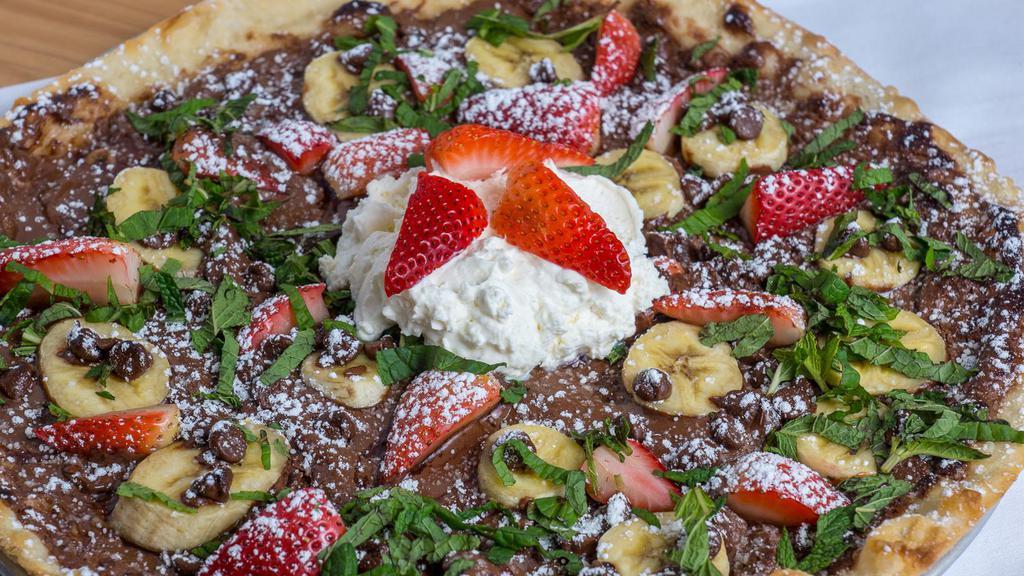 Nutella Pizza · Bananas, strawberries, mint, powdered sugar, and fresh whipped cream.