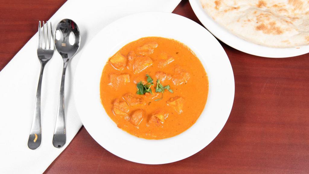 Butter Chicken · Boneless chicken chunks cooked in tandoor and mixed with mild tomato based sauce with almonds and cashews.