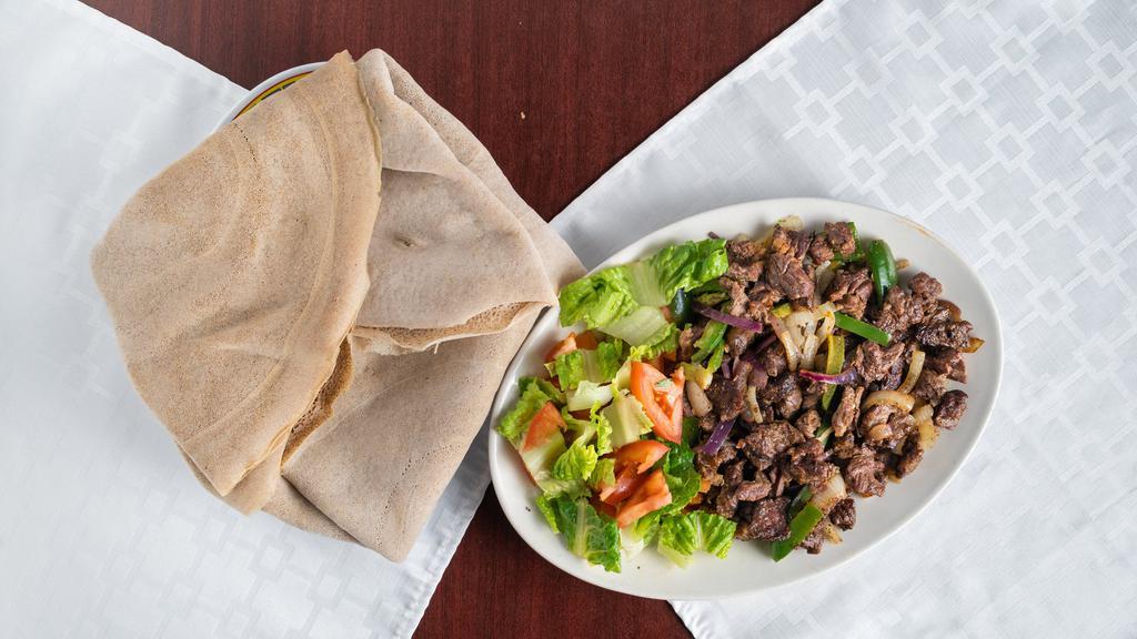 Yebeg Tibs (የበግ ጥብስ) · Most popular. Tender marinated lamb, stir-fried with onions, garlic, and tomato.
