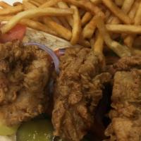 Oyster Po’ Boy · Fresh oysters lightly battered and flash fried. Served on a sub roll with lettuce, pickles a...