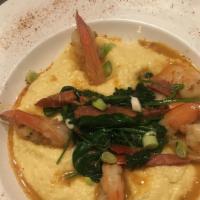Shrimp & Grits · Jumbo shrimp grilled and served over cheddar hominy grits and topped andouille ausage.
