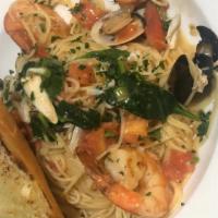 Scampi Pasta · Flavored infused white wine garlic butter sauce, lime, shallots, tomato, spinach with Parmes...