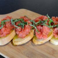 Bruschetta · Bread sliced and baked to a perfect crust and topped with marinated cherry tomatoes and basil.