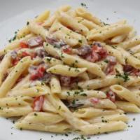Penne Cividale · Cream, chopped prosciutto, rosemary, diced tomatoes, and grated parmesan cheese.