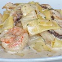 Pappardelle Mari E Monti · Calamari, Shrimp and shiitake mushrooms sautéed in cream sauce.