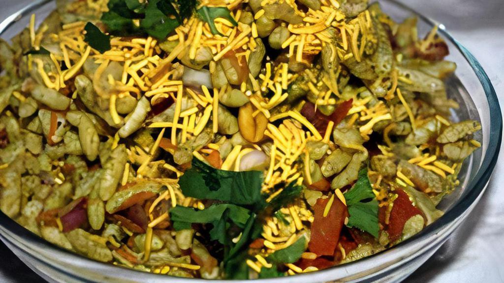 Bhel Puri · Puff rice, crisps, lentil, vermicelli, tomato, onion, chili, cilantro, mix with tamarind and mint chutney and topped with yogurt