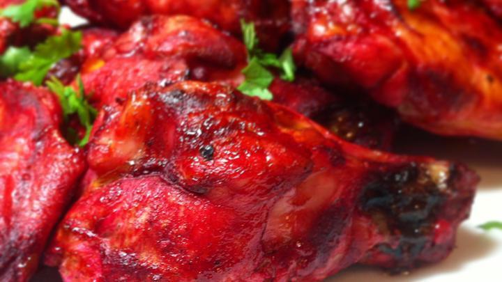 Tandoori Chicken · Bone-in chicken marinated in a yogurt, freshly ground spices and cooked in a tandoor.