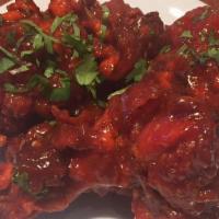 Chicken Lollypop · Pulled back chicken wings cooked in a spicy red batter.