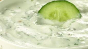 Raita · Whipped yogurt with cucumbers and spices.