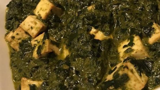 Palak Paneer · Fresh homemade cheese cooked in a creamy spinach sauce.