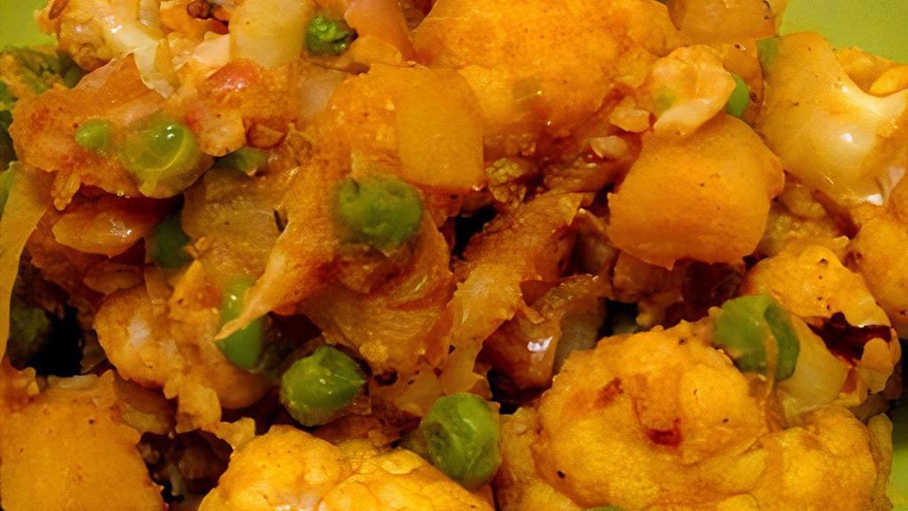 Aloo Gobi · Fresh cauliflower and potatoes cooked with ginger, tomatoes, peas and mild spices.