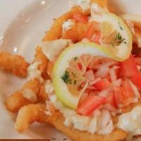 Calamari · Seasoned, lightly fried, garnished with red onion, tomatoes and capers in a lemon beurre bla...