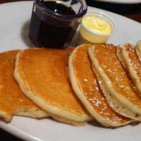 Stack Of Pancakes · Four pancakes served with butter and syrup.