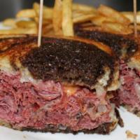 Rueben Sandwich · Corned beef on grilled rye with sauerkraut, swiss cheese, and thousand islands. Served with ...
