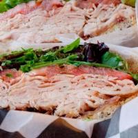 Smoked Turkey Club · The always delicious smoked turkey breast, gouda cheese, field greens, tomatoes and honey di...