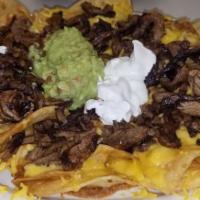 Plaza Super Nachos · Served with beans, cheese, beef or chicken fajita, guacamole, sour cream and jalapeno.