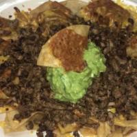 Pastor Nachos · Al pastor meat served with beans and white cheese.