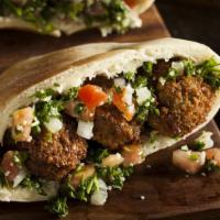 Falafel Sandwich · Chickpeas with lettuce, tomatoes, onions, pickles, radishes and tahini sauce.