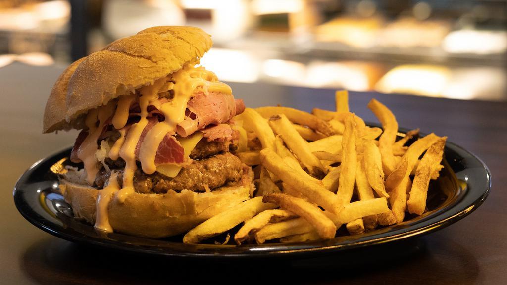 Reuben Burger · Half pound hamburger topped with your choice of Reuben served on grilled rye.