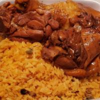 Stewed Chicken · Stewed chicken served with rice (white or yellow) and beans.