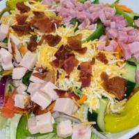 Cobb Salad · Mixed greens topped with apple smoked bacon, scallions, tomato, onions, egg and blue cheese ...