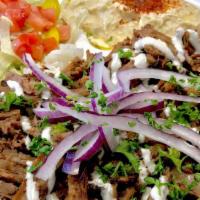 Beef Shawarma Plate · Served with Rice, Hummus, Salad topped with Onions drizzled with Tahini. Pita Bread.