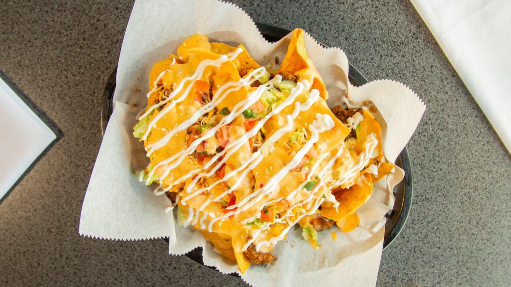 Loaded Nachos · Choice of meat, tortilla chips, queso, lettuce, cheese, pico de gallo and sour cream.