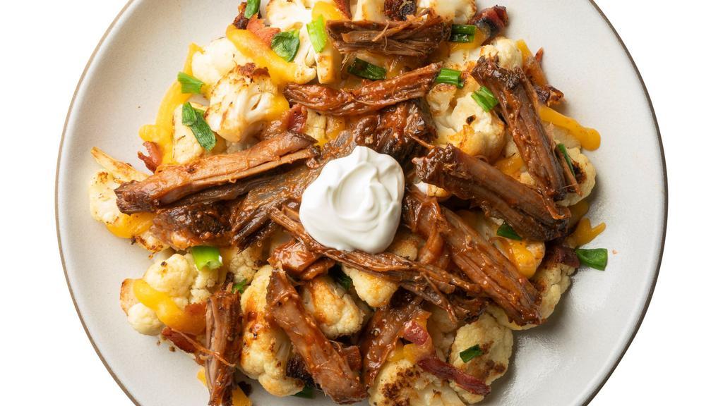 Peach Bbq Brisket With Loaded Cauliflower · Just like your favorite BBQ joint, but with a peachy refresh. Served with better-for-you loaded roasted cauliflower and topped with sour cream, bacon, and green onions.