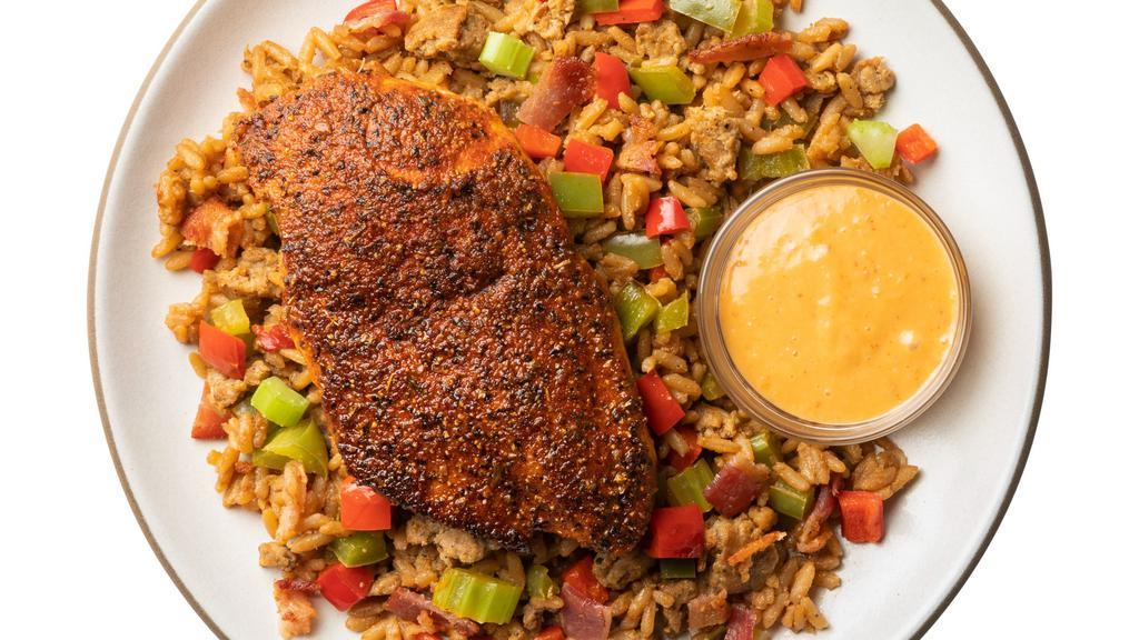 Cajun Chicken With Dirty Rice & Remoulade Sauce · Louisiana classics – re-imagined. Cajun-spiced chicken breast served alongside a brown rice pilaf with peppers and bacon, accompanied by a creamy remoulade sauce.