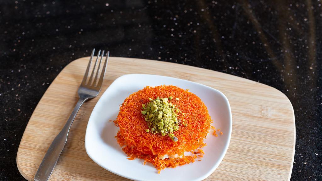Knafeh · Shredded kataifi dough filled with soft white cheese, topped with rosewater syrup and chopped pistachios.