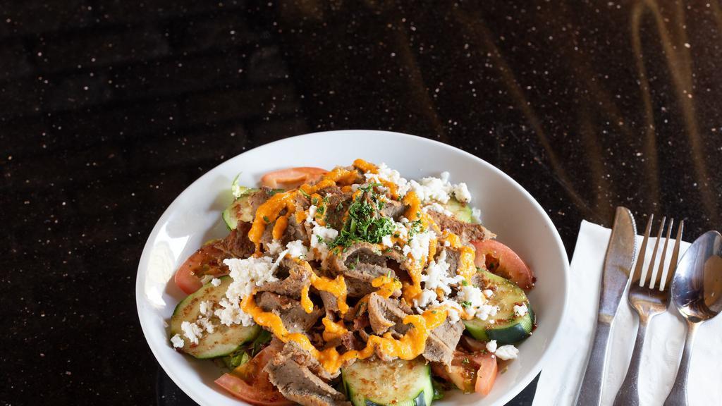 Gyro Salad · Halal. Gyro meat (lamb and beef mixture), lettuce, tomatoes, cucumbers, feta cheese, vinaigrette dressing and topped with spicy garlic sauce.