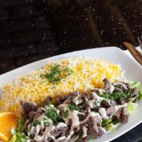 Lamb Shawarma Plate Lunch · Gluten-free, halal. Marinated lamb on a bed of lettuce, topped with tahini sauce. Served wit...