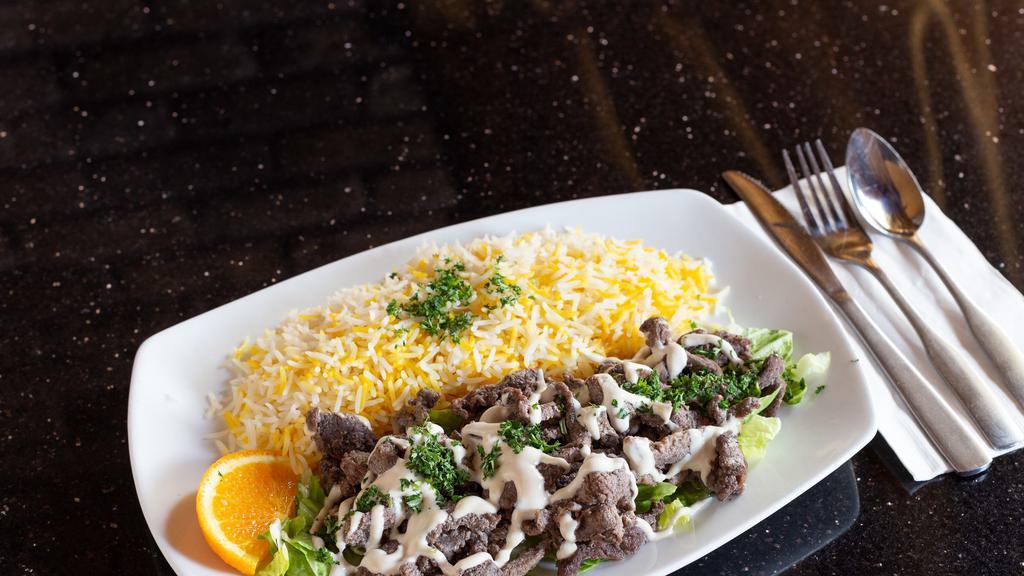 Lamb Shawarma Plate Lunch · Gluten-free, halal. Marinated lamb on a bed of lettuce, topped with tahini sauce. Served with basmati rice.