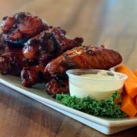Fire Grilled Wings · Jumbo wings grilled with ancho chili glaze, tequila lime blue cheese, and carrots.