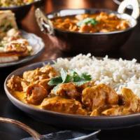 Chicken Butter Masala · Contains nuts. Boneless chicken pieces are marinated and cooked in a buttery yogurt sauce.