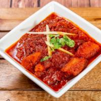 Goanese Chicken Vindaloo · Chicken cooked with potatoes, red chilies, ginger, garlic, cumin, and vinegar-based spices.