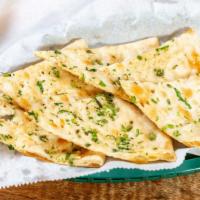 Garlic Naan · Soft flour bread baked and topped with fresh minced garlic.